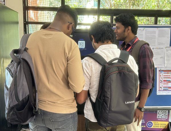 Students gathered at the PrintnFlow kiosk screen, scanning to print